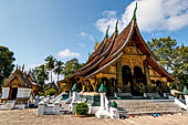 Wat Xieng Thong temple in Luang Prabang, Laos.  A view of the 'sim' with the large sweeping roof. 